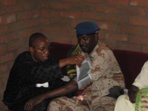 Dr. Eni, left, taking a soldier's blood pressure on a recent mission trip to Chad