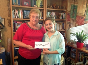 Isabella presents her birthday donations to Board Member Barb Hodges